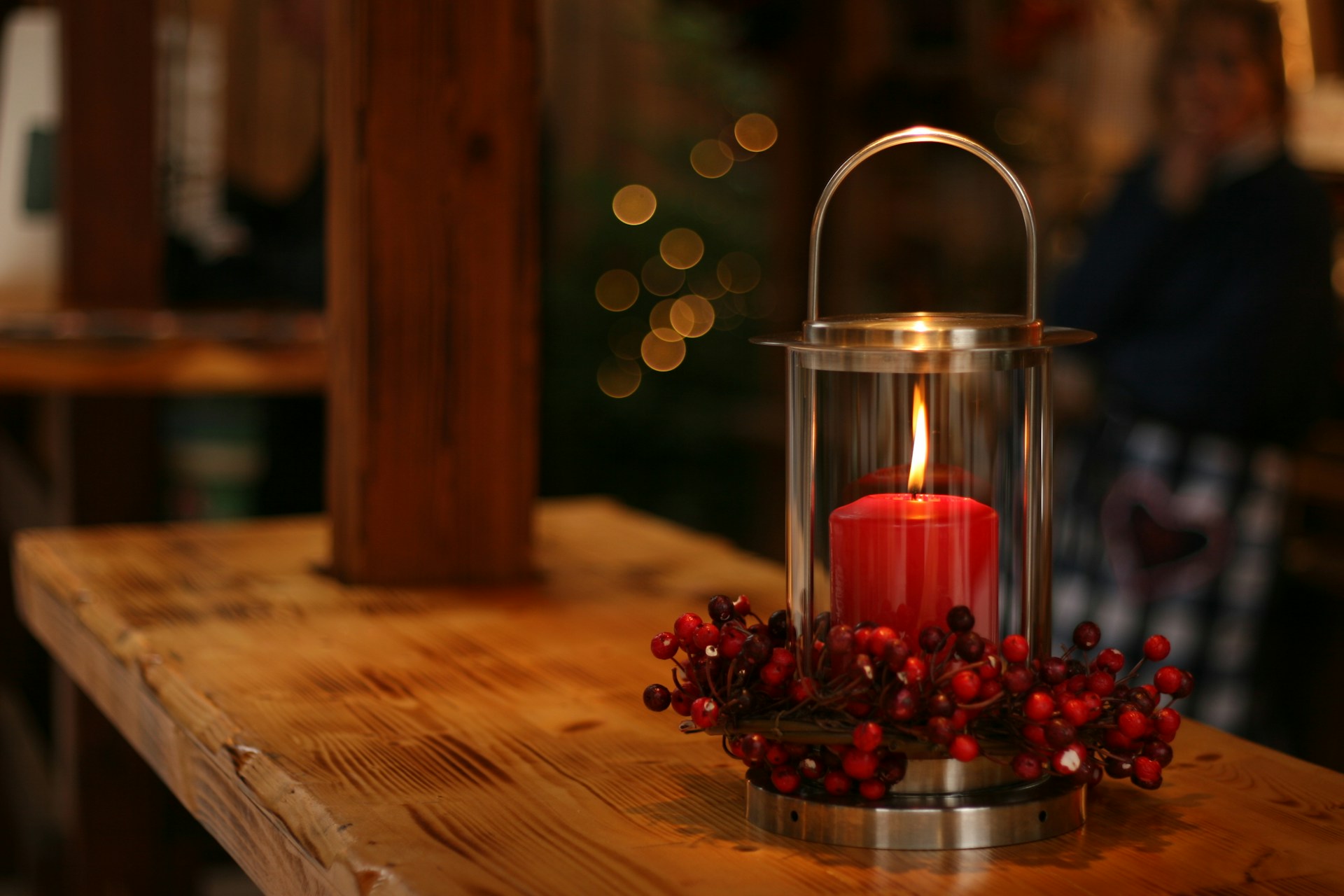 Table with Christmas candle burning